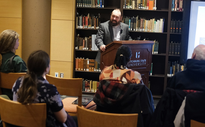 JJ Sylvia lecturing in library archives.