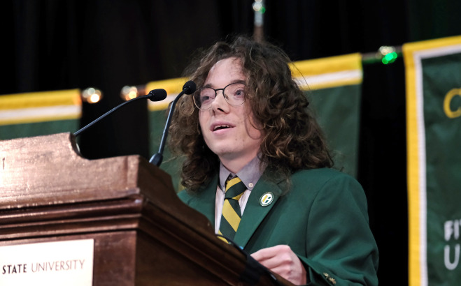 Michael Burns ACT, SGA President speaking at podium.