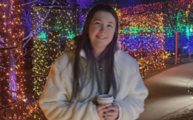 Quinn Donnelly outside with Christmas lights.
