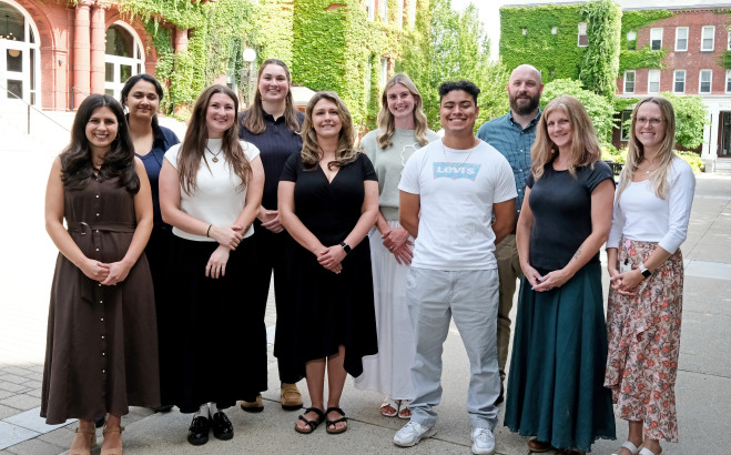 Group photo of the counseling services staff in front of Thompson and Miller Hall.