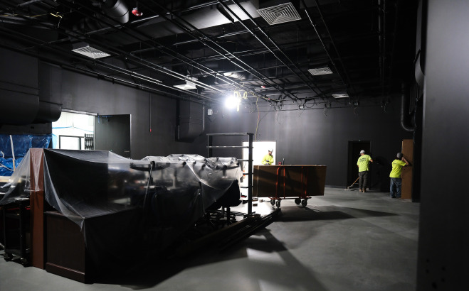 Film Video studio space construction with workers and equipment.