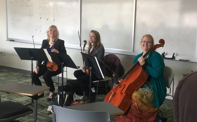 Three instructors playing string instruments