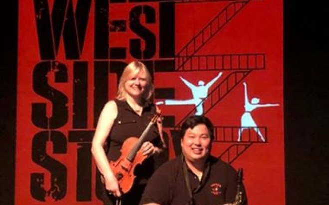 Three performers posing with a cello and a piano