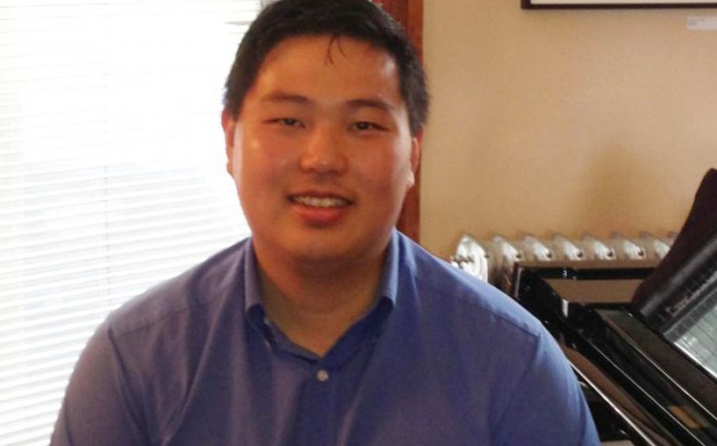 Matthew Kim sitting at piano.