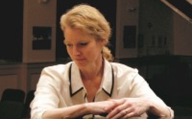 Pamela Hines sitting at piano.