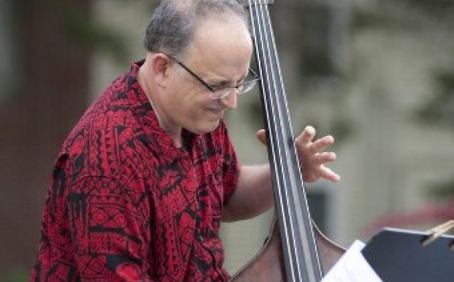 Stephan Arsenault playing the cello outside.