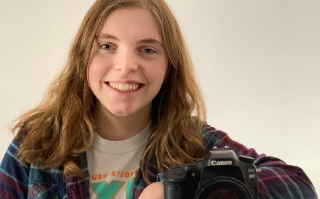 Buffy Cautela with arm on camera.