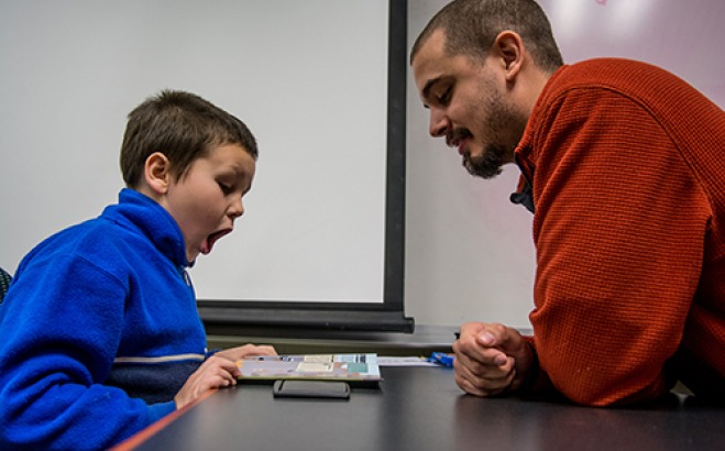 Student reading with a child