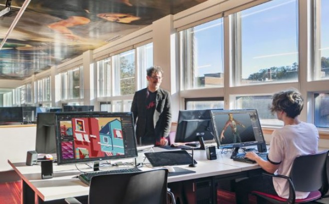 Professor Jeffrey Warmouth and student Jules Stackhouse in the game design studio at the theater&hellip;