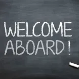 Black chalkboard with "WELCOME ABOARD!" written in white chalk.