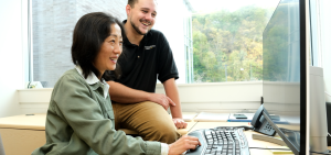 Jane Huang and alum Tristan Taylor at computer