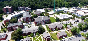 Aerial drone shot of campus buildings from Cedar St facing smokestack