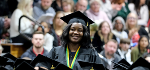 Mary Nankya smiles at Winter 2023 commencement ceremony
