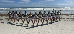 Fitchburg State cheerleading squad in Florida on the beach