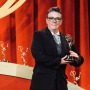 Julie Naff holding her Emmy award