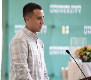 Steven Martinez '17 accepting alumni award 2023