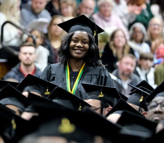 Mary Nankya smiles at Winter 2023 commencement ceremony