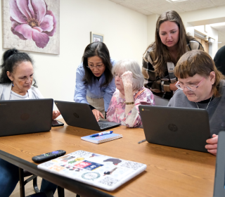 Jane Huang and Mary Kate Moreau work with residents for Digital Equity project at Joseph House