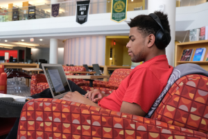 Student using laptop in campus library