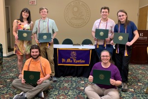 Math Honor Society (PME) Inductees 2023 posing with their awards in President's Hall