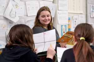 Student teaching at McKay reading to two female students