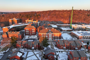 Aerial quad at sunrise in winter with snow on ground and moon in sky