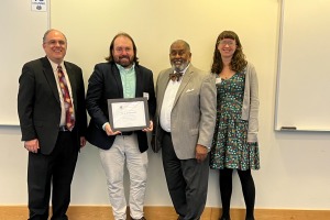 Professor JJ Sylvia IV receiving OER award May 2025