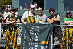 Homecoming students in the bleachers at the football game