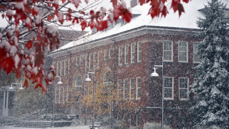 Snowy view of Edgerly Hall with red foliage