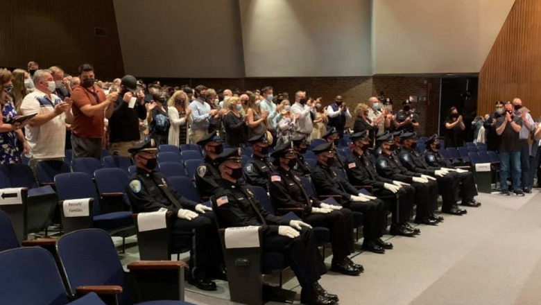 Police program officers are applauded in Weston Auditorium
