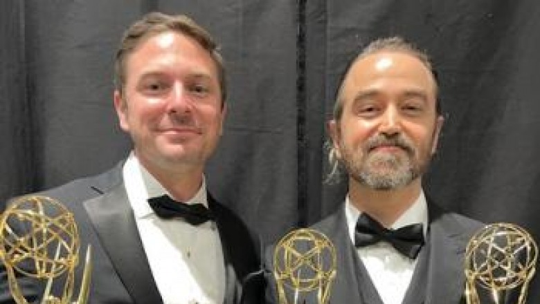 Emmy winning alumnus Gregg Swiatlowski, left, with his award