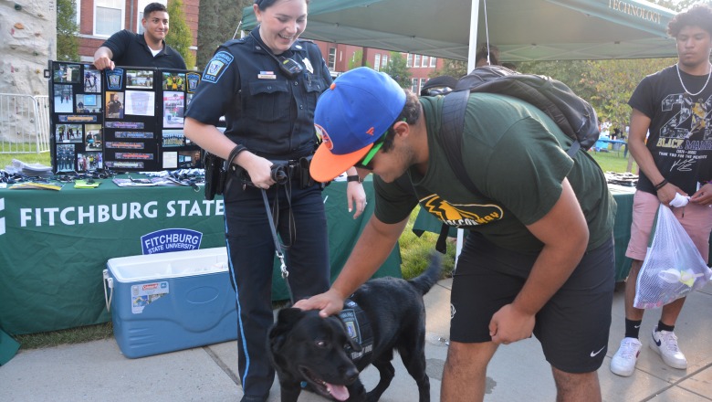 Photo of police dog Odin greeting students with Officer Erin Morreale