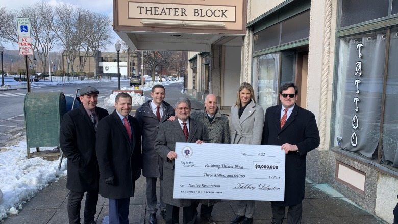 Leaders pose with check for theater block renovations