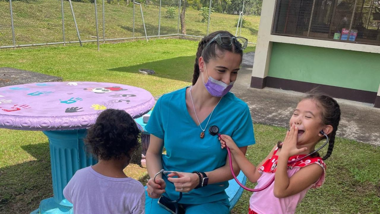 Nursing student Genevieve Casucci with children on a trip to Costa Rica