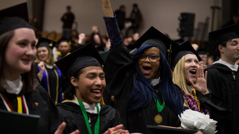Male and female graduates smiling and celebrating at winter commencement