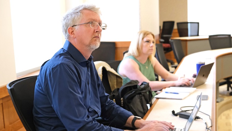 Faculty Academy - Sean Goodlett lead at table with laptop 