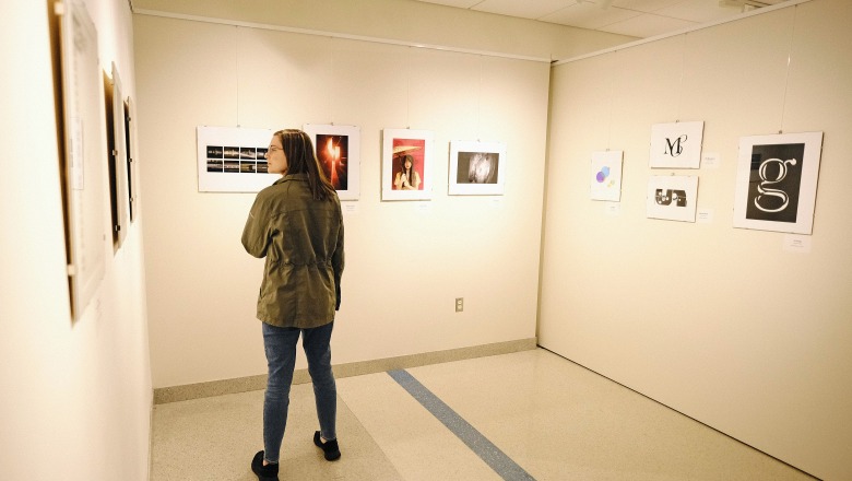 Female student in art gallery looking at exhibits