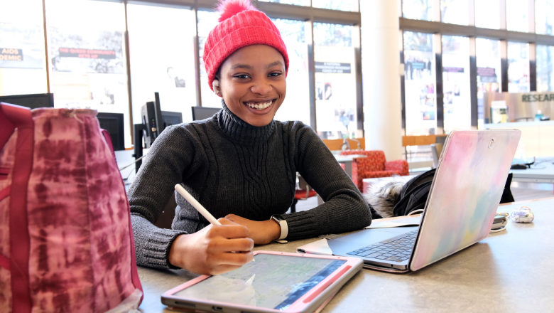 Student smiling in campus library