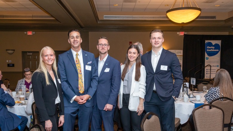 from left, Fitchburg State student Madison Pinard, Fidelity Bank Chief Lending Officer Joseph Silva, Fidelity Bank Senior Vice President Derek Beahn, and Fitchburg State students Emma Beqiri and Toivo Kramer.