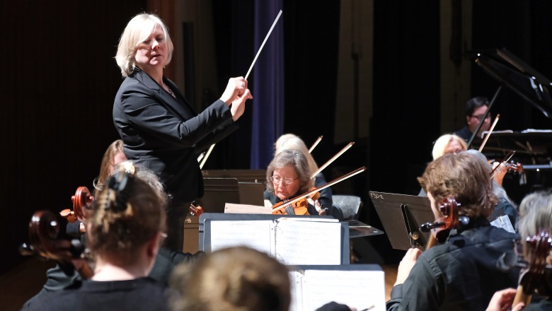 Hildy S conducting community orchestra in Weston