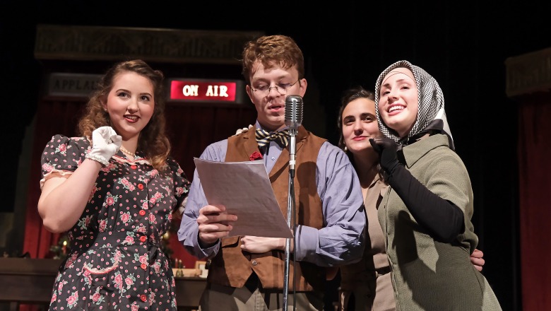 One male and three female actors performing in front of the microphone on stage