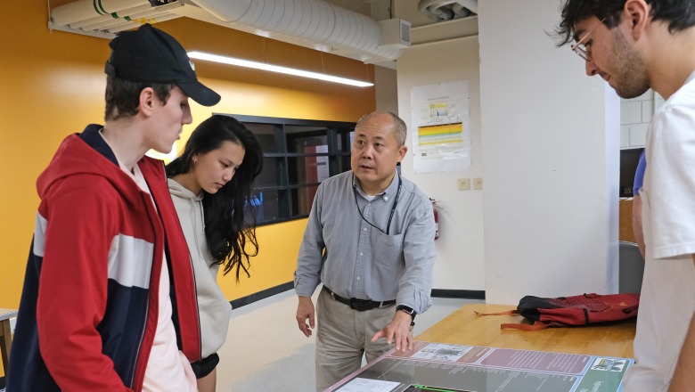Professor talking with students in an Engineering Technology classroom