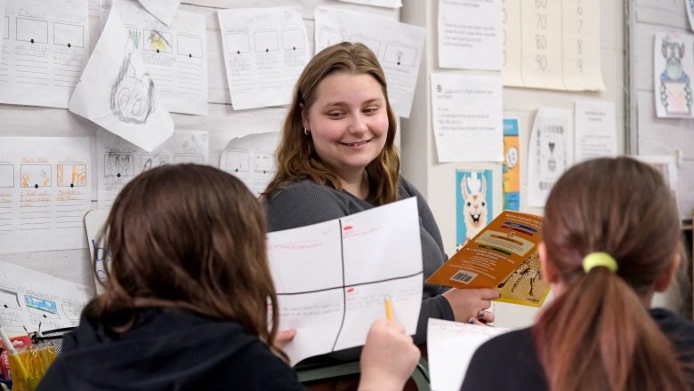 Student teaching at McKay reading to two female students