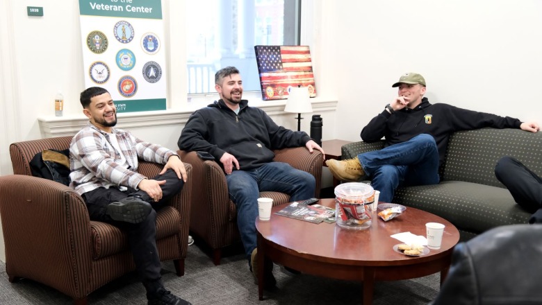 Male students sitting and laughing in the Veterans Center