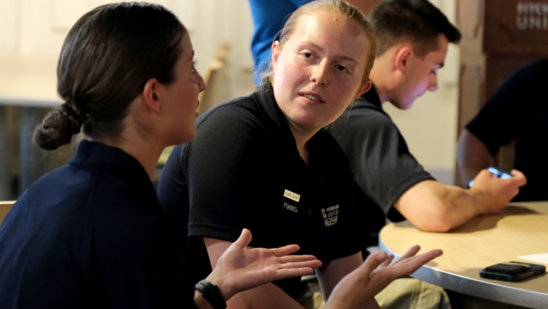 Two female police students talking