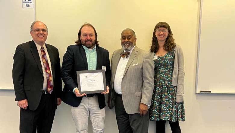 Professor JJ Sylvia IV receiving OER award May 2025
