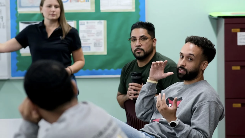 Eliezer Rivera and Fernando GR talking to students at Fitchburg High School.