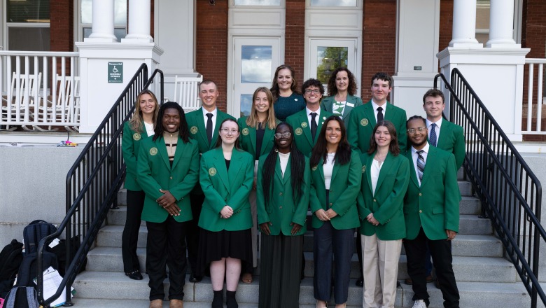 Presidential Ambassadors take photo with Pesident Hodge in front of Thompson Hall