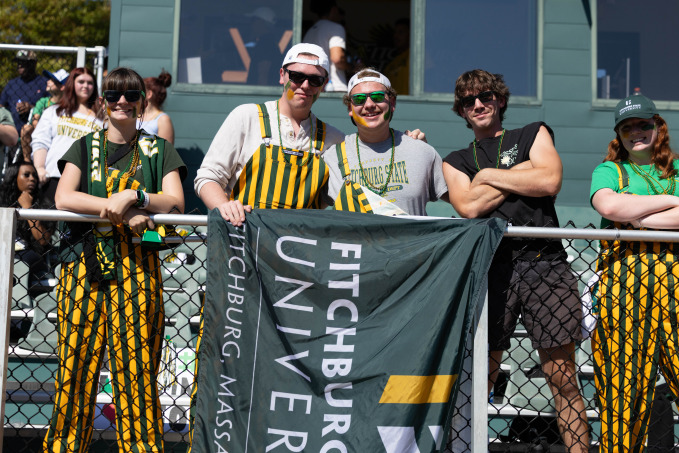 Homecoming students in the bleachers at the football game