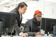 Engineering professor Nirajan Mani and student at computer in classroom